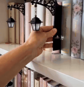 A cozy ghost lantern lighting up a bookshelf